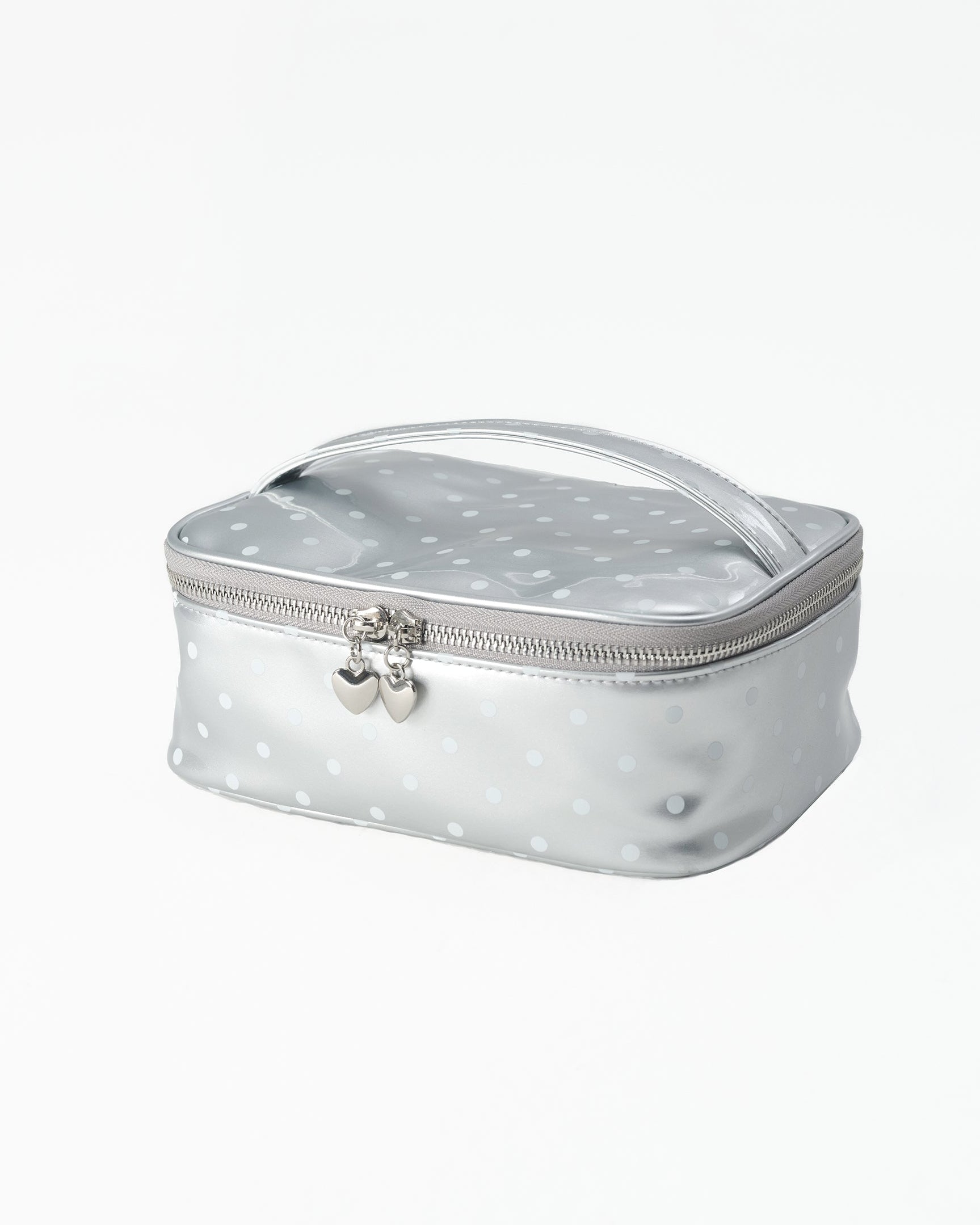 A silver metallic cosmetic pouch with a white polka dot pattern, featuring a top handle and a silver zipper pulls, set against a plain white background.