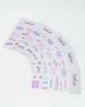 A set of printed cards or labels fanned out on a plain white background. The cards feature multiple colorful logos and text, including 'Friend Crush', 'Diva', 'Cult Leader', 'Cute, Chaotic & Critical Thinking', 'Flop Era Survivor', and 'Hot & Having Fun'.