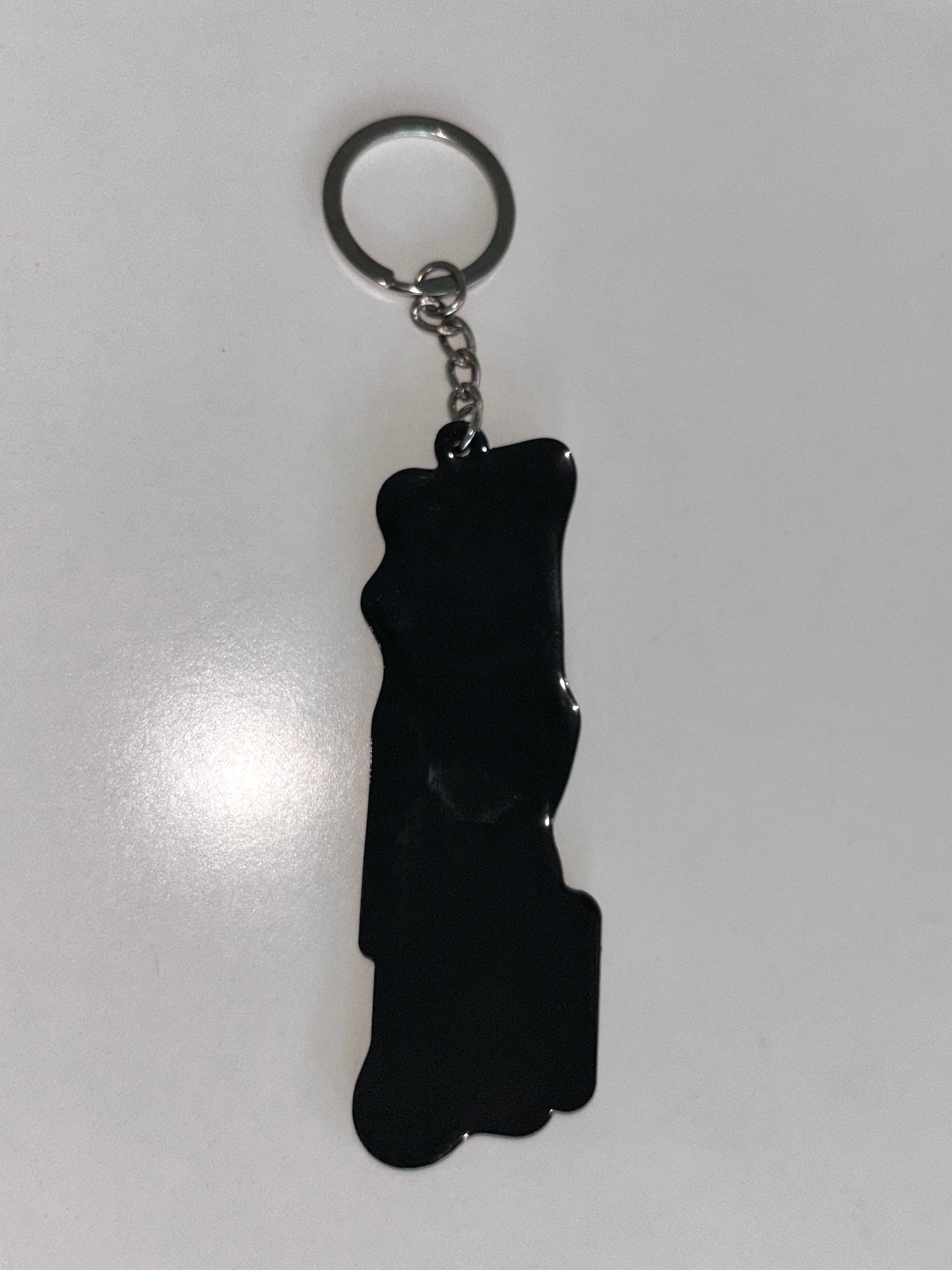 A black silicone keychain with a silver metal split ring and chain, shown on a plain light gray background.